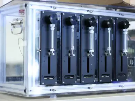 Syringe pumps and motor controllers in custom fiberglass housing for gel electrophoresis cartridge casting automation.